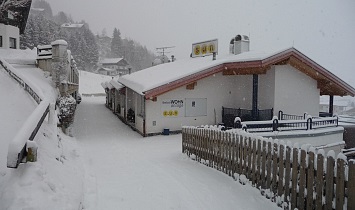 Entrance to the Classic apartments in deep snow-covered Matrei in Osttirol